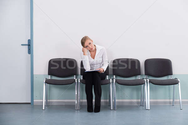 Fiatal üzletasszony álmodozás ül szék üzlet Stock fotó © AndreyPopov