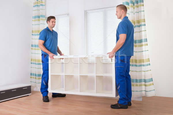 Movers Carrying Shelf At Home Stock photo © AndreyPopov