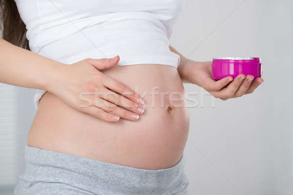 Pregnant Woman Applying Cream On Her Belly Stock photo © AndreyPopov