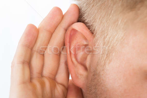 Person Trying To Hear With Hand Over Ear Stock photo © AndreyPopov