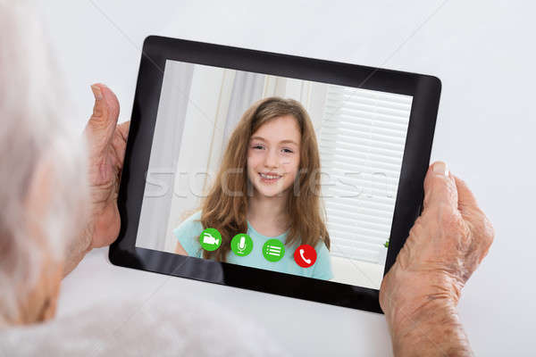 Grandmother Video Conferencing On Digital Tablet Stock photo © AndreyPopov