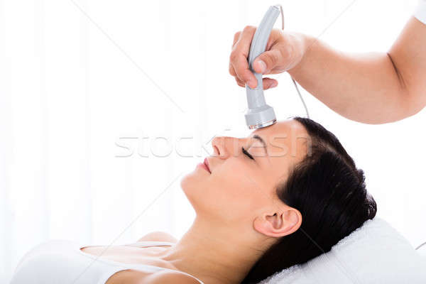 Woman Receiving Microdermabrasion Therapy On Forehead Stock photo © AndreyPopov