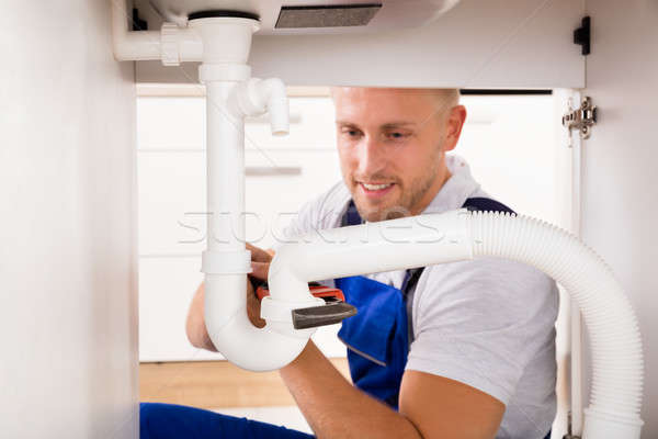 Plumber Tightening Sink Pipe Stock photo © AndreyPopov