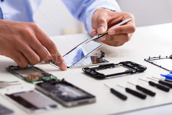 Technician Fixing Damaged Screen On Mobile Phone Stock photo © AndreyPopov