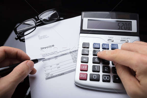 Businessperson Calculating Invoice Stock photo © AndreyPopov