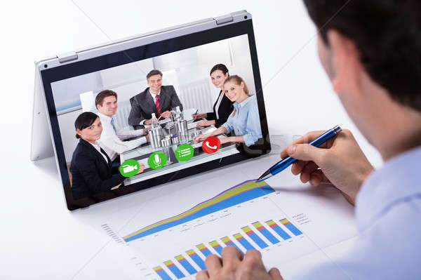 üzletember videó hibrid laptop kollégák asztal Stock fotó © AndreyPopov