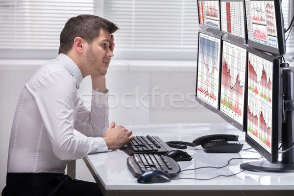 Stressed Male Operator Looking At Graphs Stock photo © AndreyPopov