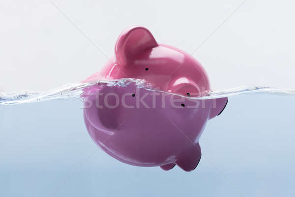 Stock photo: Piggy Bank Drowning In Water