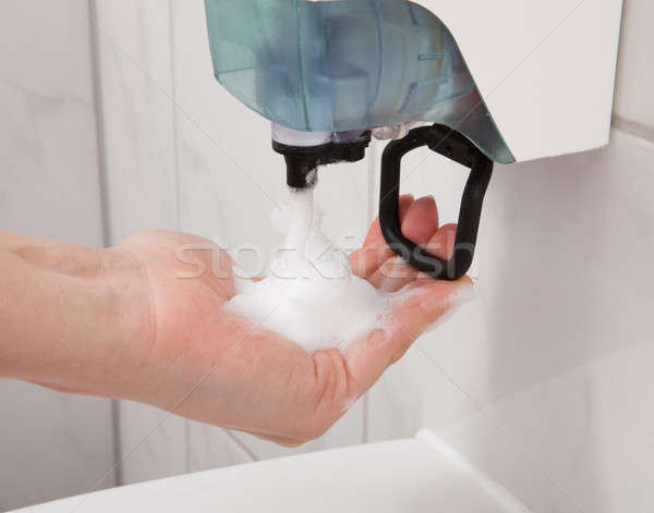 Hand using soap dispenser Stock photo © AndreyPopov