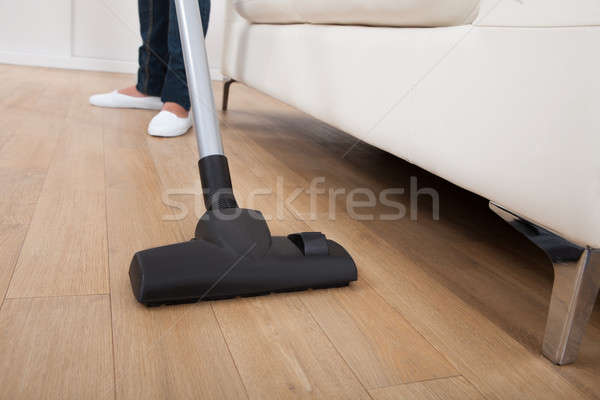Low Section Of Woman Vacuuming Floor Stock photo © AndreyPopov