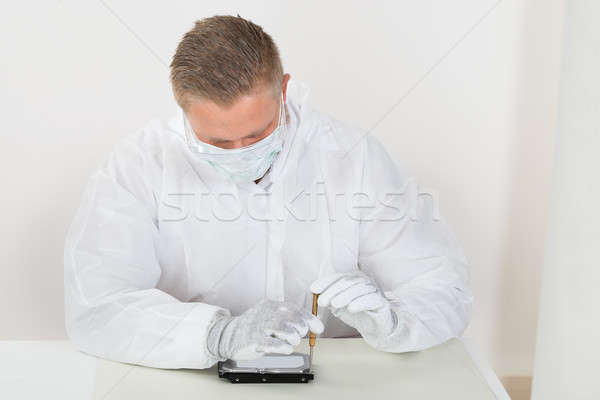 Stock photo: Man Wearing Mask And Glove Repairing Harddisk