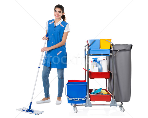 Happy Female Janitor Mopping By Trolley On White Background Stock photo © AndreyPopov