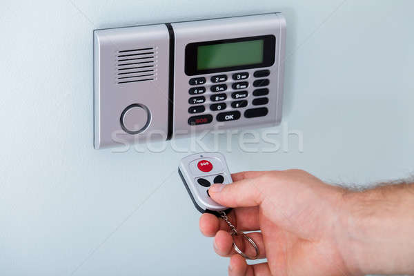 Person Hand Using Remote To Operate Security System Stock photo © AndreyPopov