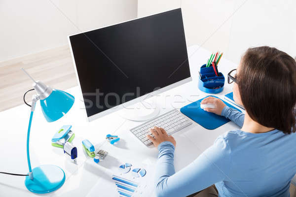 Businesswoman Using Computer On Desk Stock photo © AndreyPopov
