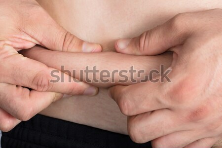 Man Pinching Excessive Stomach Fat Stock photo © AndreyPopov