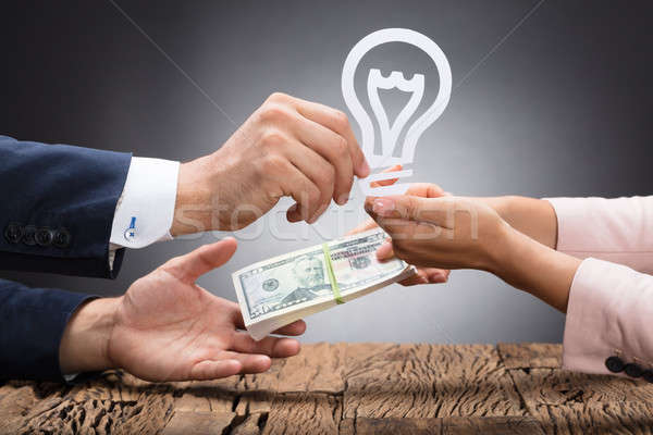 Businessperson Exchanging Idea With Currency Stock photo © AndreyPopov