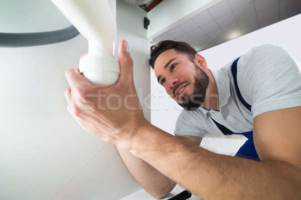 Plumber Examining Sink Pipe Stock photo © AndreyPopov
