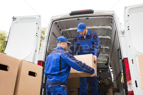 Two Movers Carrying Cardboard Box Stock photo © AndreyPopov