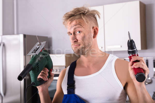 Workman Holding Electric Drill And Screwdriver Stock photo © AndreyPopov