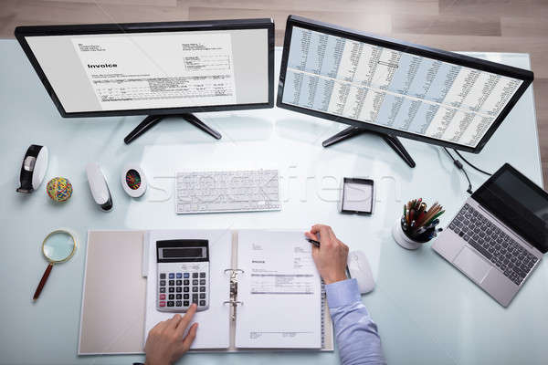 Businessperson Calculating Invoice With Calculator Stock photo © AndreyPopov