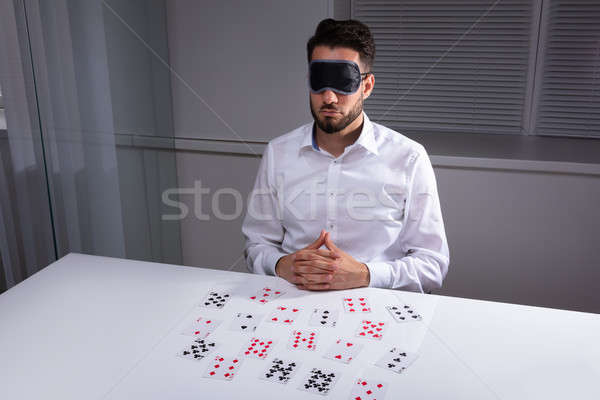 Blindfolded Businessman Reading Cards In Office Stock photo © AndreyPopov