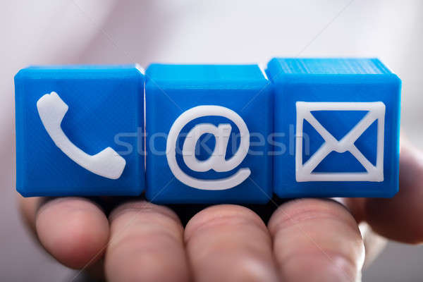 Person holding cubic blocks with various contact options Stock photo © AndreyPopov