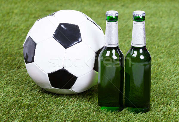 Stock photo: Soccer Ball And Beer Bottles On Green Grass