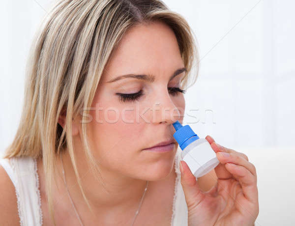 Woman using nasal spray Stock photo © AndreyPopov