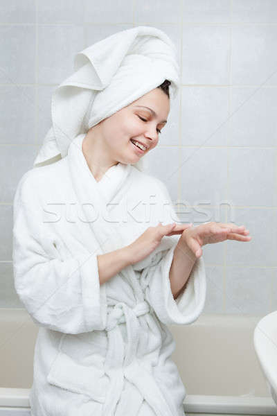 Stock photo: Woman applying moisturizer