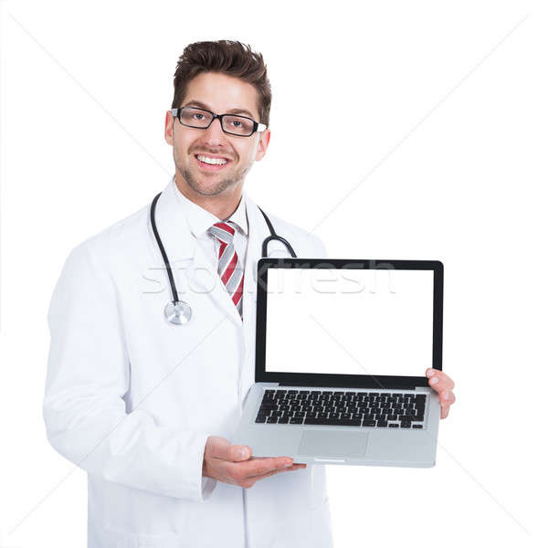 Smiling Young Male Doctor Displaying Laptop Stock photo © AndreyPopov