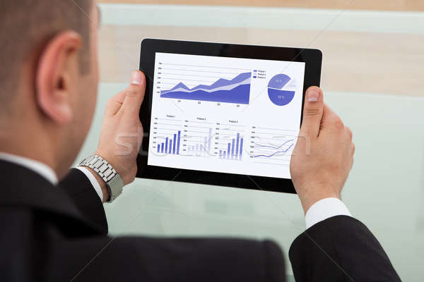 Businessman Checking The Stock Market On Digital Tablet Stock photo © AndreyPopov