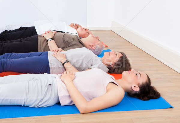Trainer And Senior People Lying On Exercise Mats Stock photo © AndreyPopov