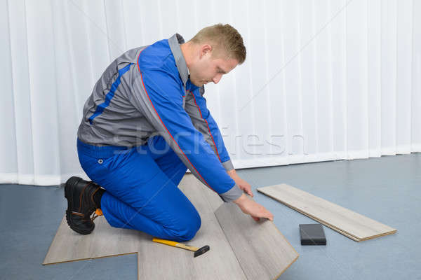 Worker Assembling New Laminate Floor Stock photo © AndreyPopov
