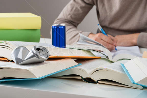 Student With Crashed Drink Can And Books At Table Stock photo © AndreyPopov