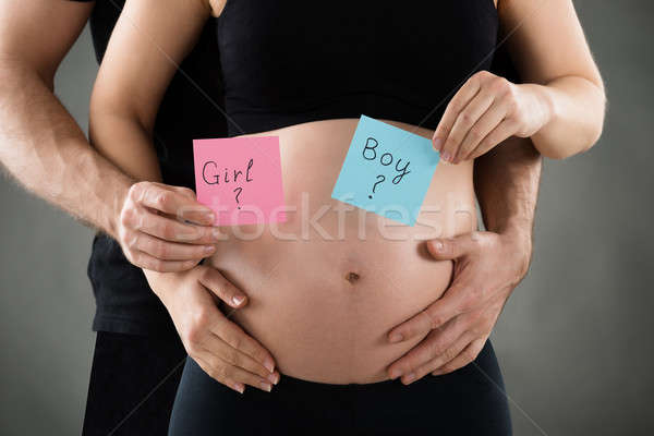 Expecting Couple Holding Paper With Boy And Girl Text Stock photo © AndreyPopov