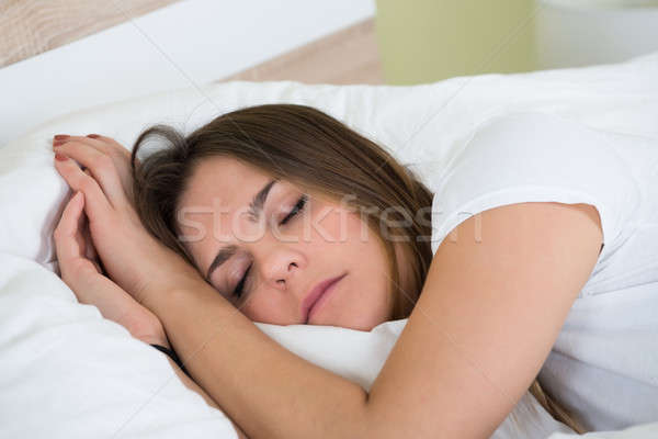 Young Woman Sleeping In Bedroom Stock photo © AndreyPopov