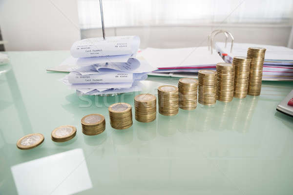 Stack Of Coins With Paper Nail On Desk Stock photo © AndreyPopov