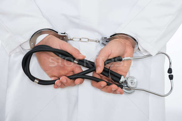 Medico di sesso maschile mani manette primo piano stetoscopio medico Foto d'archivio © AndreyPopov