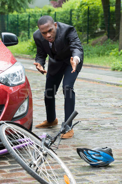 Male Driver Looking At Bicycle After Collision On Street Stock photo © AndreyPopov