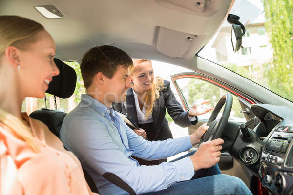 Saleswoman Showing Car To Couple Stock photo © AndreyPopov