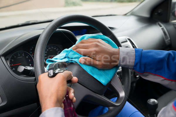 Worker Wiping Steering Wheel In Car Stock photo © AndreyPopov
