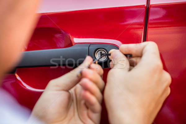 Person Opening Car Door With Lockpicker Stock photo © AndreyPopov