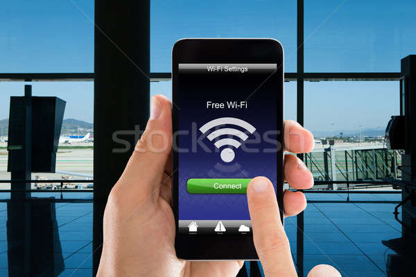 Person's Hands Using Free WiFi On Smart Phone In Airport Stock photo © AndreyPopov