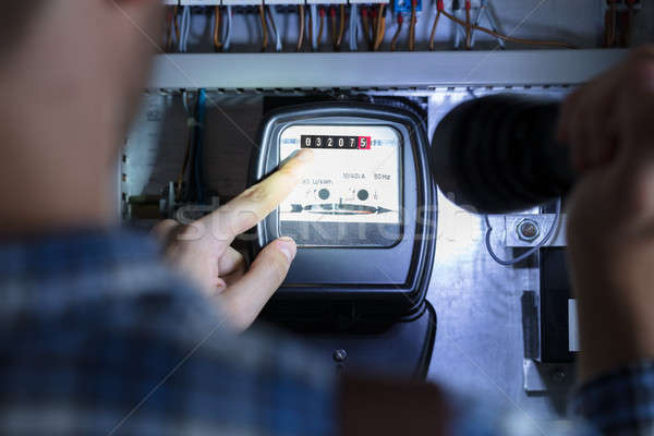 Finger Pointing To Electric Meter Reading Stock photo © AndreyPopov