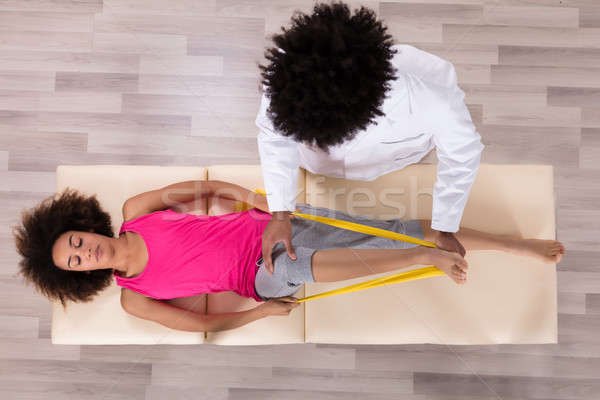 Female Patient Using Ribbon While Doing Exercise Stock photo © AndreyPopov