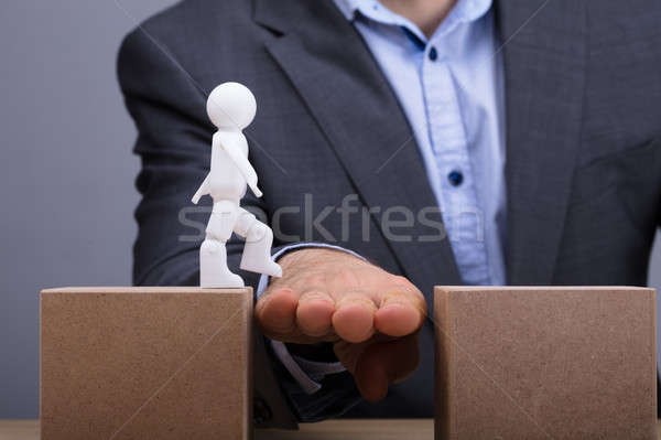 Person Helping Human Figure While Walking Between Two Boxes Stock photo © AndreyPopov