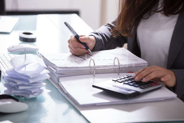 Businesswoman Calculating Invoice Stock photo © AndreyPopov