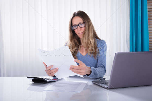 Businesswoman Reading Document In Office Stock photo © AndreyPopov