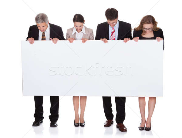 Stock photo: Businesspeople holding a blank banner