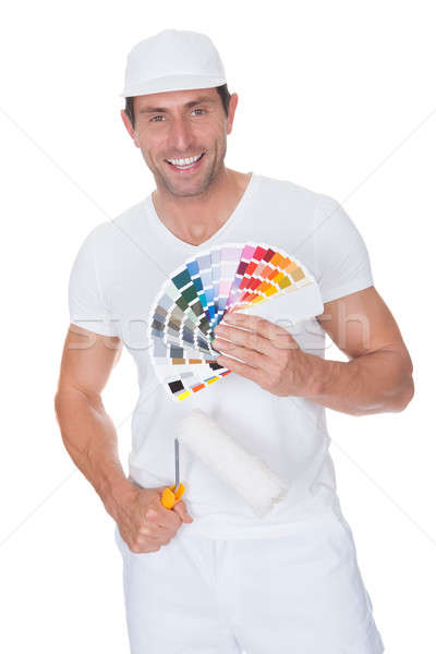 Stock photo: Painter Holding A Paint Roller And Spectrum